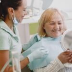 Senior woman at a dental check-up with her dentist, illustrating a visit to address bleeding gums