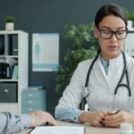 A doctor consulting with an older patient about low blood sugar symptoms during a medical visit