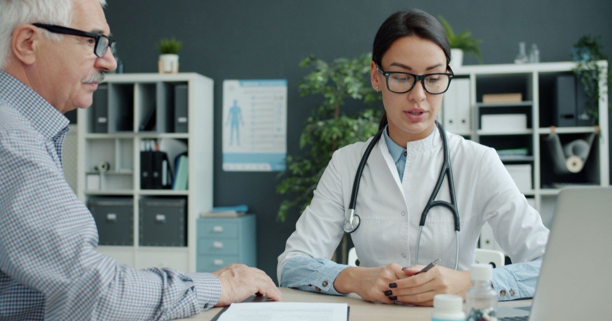 A doctor consulting with an older patient about low blood sugar symptoms during a medical visit