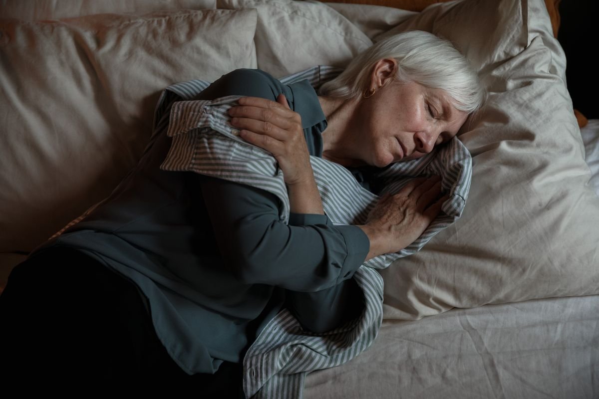 Senior woman sleeping peacefully in bed at night