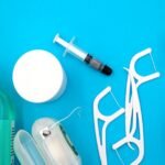 Oral care items including mouthwash, floss, and toothbrushes arranged on a blue background