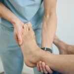 Physiotherapist performing foot therapy for a patient with nerve-related foot symptoms