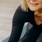 Senior woman doing a gentle seated stretch for sciatica relief