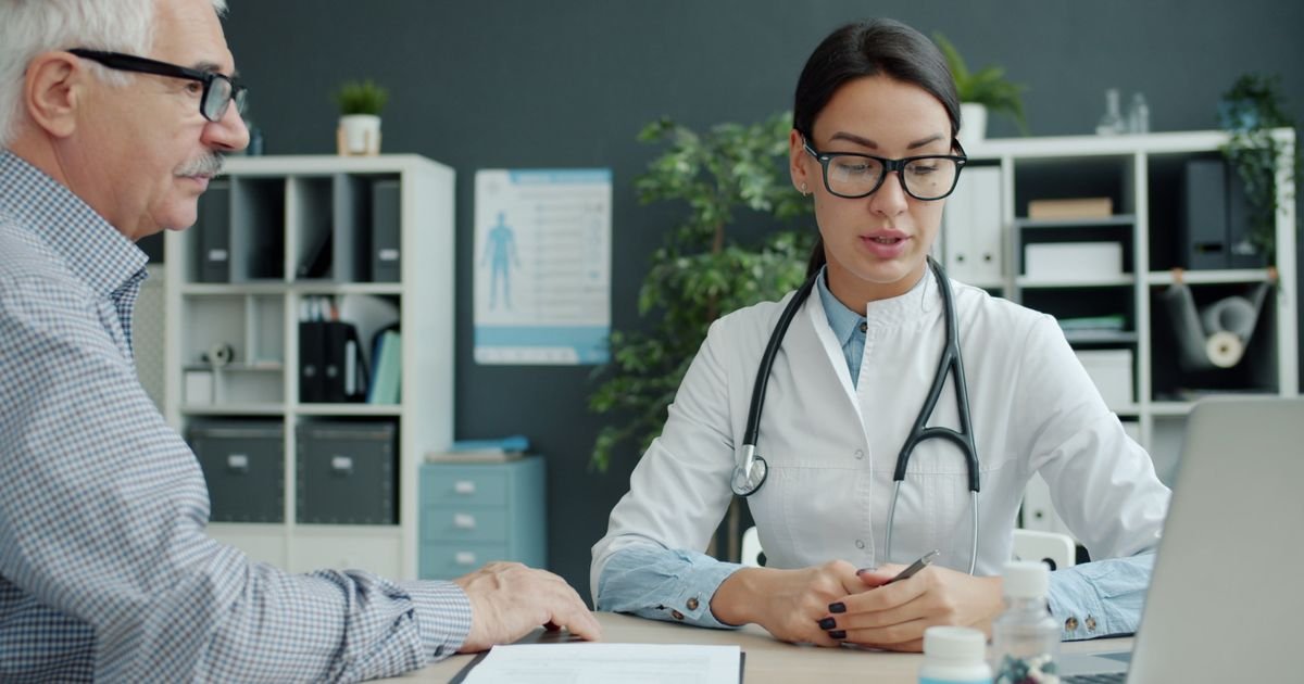 Senior man discussing his blood test results with his doctor in a medical office