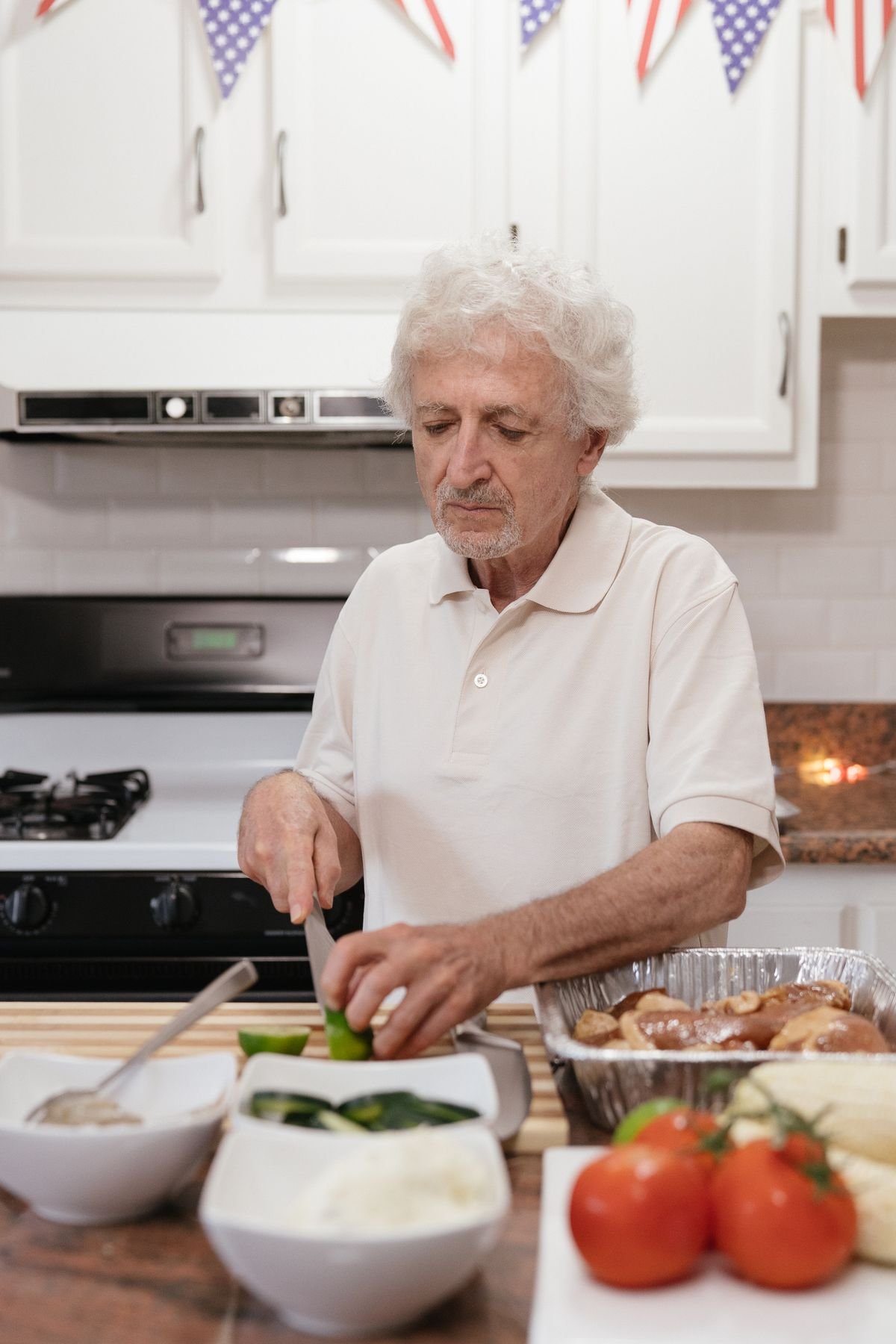 Senior man preparing fresh vegetables in his home kitchen