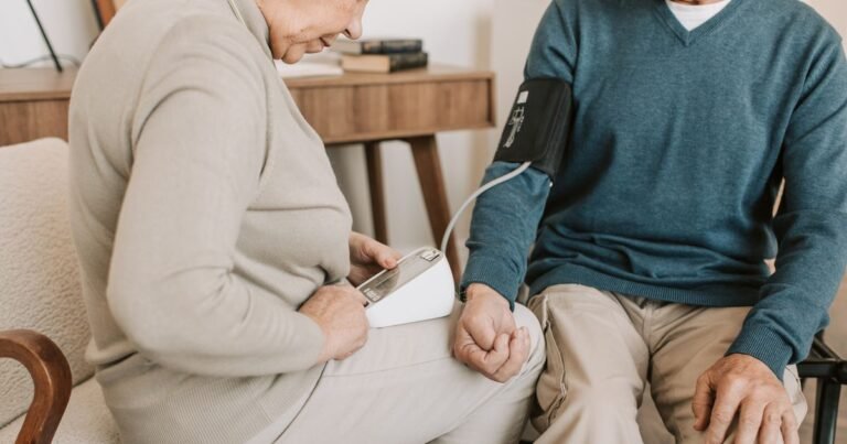 Senior couple at home checking blood pressure together