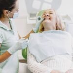 Senior woman smiling during a dental checkup with her dentist