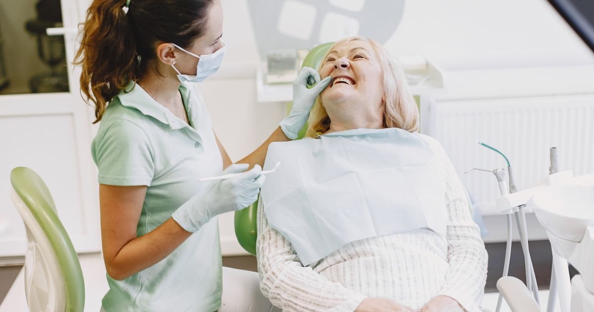 Senior woman smiling during a dental checkup with her dentist