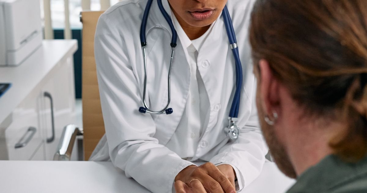 Pharmacist reviewing a medication bottle and explaining dosage to an older patient