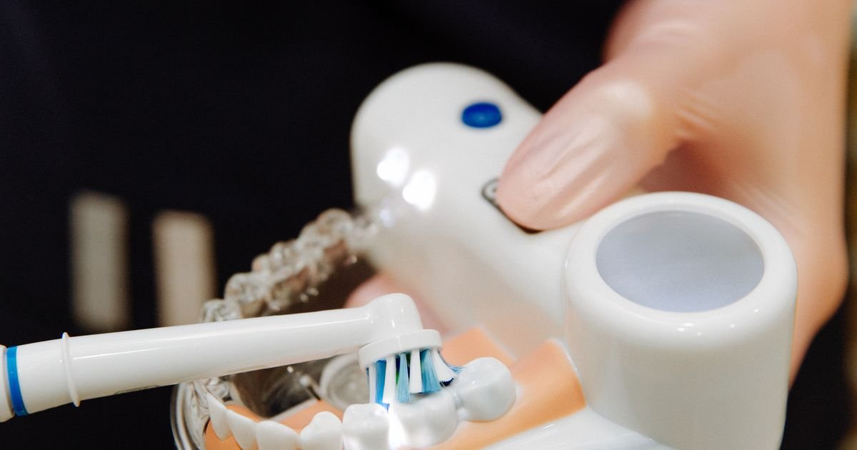 Dentist examining an older adult patient's mouth during a routine dental checkup
