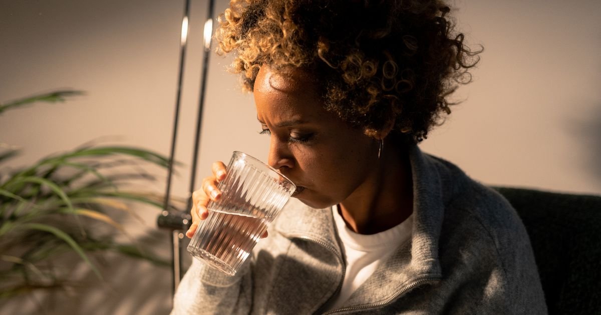 Older woman drinking a glass of water