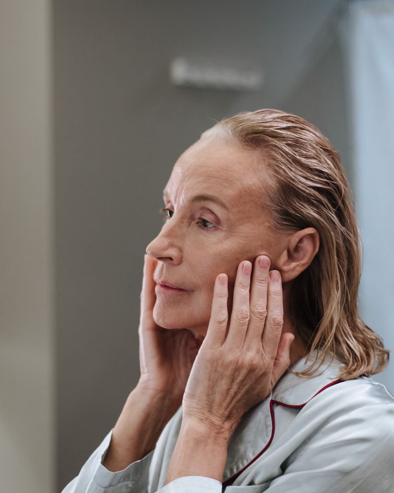 Senior woman gently caring for her skin as part of a daily skincare routine