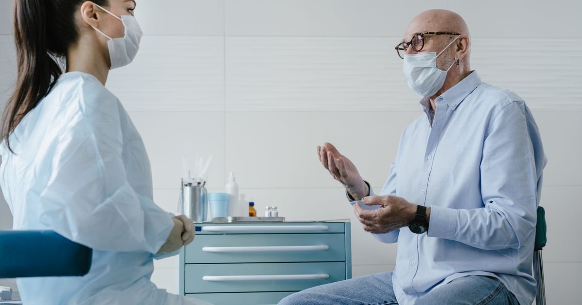 Senior man discussing health concerns with a medical professional in a clinic