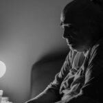 Older woman sitting awake in bed at night, unable to sleep